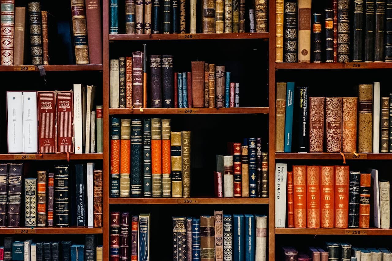 A dense wall of leather-bound books on wooden shelves